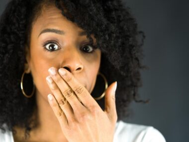 woman covering her mouth to prevent hiccups